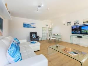 a living room with a white couch and a glass table at Apartment The LightHouse by Interhome in Albufeira