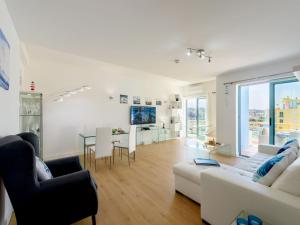 a living room with a white couch and a table at Apartment The LightHouse by Interhome in Albufeira
