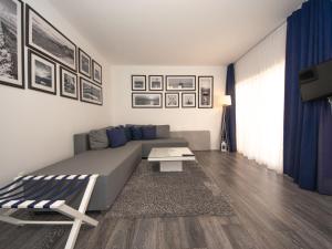 a living room with a couch and a table at Apartment Sunset-13 by Interhome in Vir