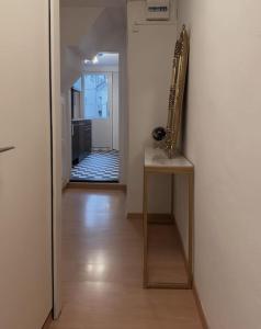 a hallway with a table and a saxophone on a wall at Süsse Wohnung in Zürcher Altstadt 3 in Zürich