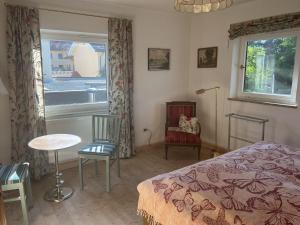 a bedroom with a bed and a table and a window at Ferienhaus zur schönen Aussicht in Teisendorf