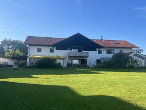 a large white house with a large green lawn at Ferienhaus zur schönen Aussicht in Teisendorf