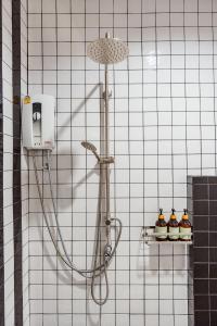 a shower in a white tiled bathroom at Prime Villa Hua Hin in Ban Thap Tai (1)