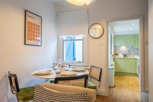 a dining room with a table and chairs and a kitchen at 17 Trinity Lane in York