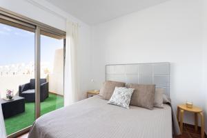 a bedroom with a bed and a large window at River Loft Vista Marina in El Médano