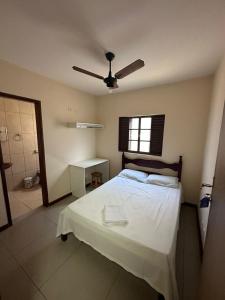 Schlafzimmer mit einem Bett und einem Deckenventilator in der Unterkunft HOTEL VARGINHA II in Varginha