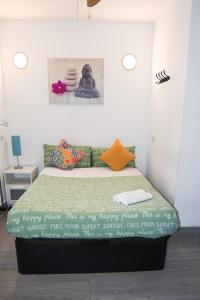 a bedroom with a bed with a poster on the wall at LOFTS ARENAL in Madrid
