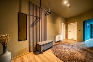 a living room with a bench and a rug at LLR Design Apartment - Emerald Green im Zentrum von Koblenz in Koblenz