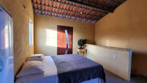 a bedroom with a large bed in a room at Vila Coqueiro - Moitas in Amontada