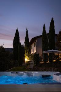 a house and a swimming pool at night at Agriturismo Santo Stefano in Polvano