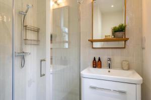 a bathroom with a white sink and a shower at 17 Trinity Lane in York