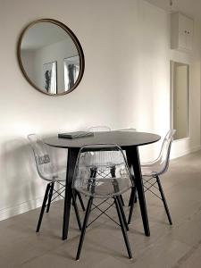 a dining room table with two chairs and a mirror at Central 2-bedroom apartment, Montrose in Montrose