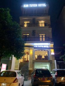 a hotel with cars parked in front of it at Kim Tuyen Hotel in Ninh Binh