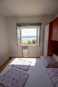 Postel nebo postele na pokoji v ubytování Apartmani Vesna