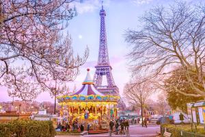a carnival ride in front of the eiffel tower at Luxury Flat With Terrace & Eiffel Tower View in Paris