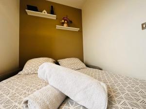 a bedroom with a bed with two towels on it at Luxury Flat With Terrace & Eiffel Tower View in Paris