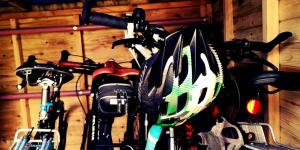 a group of bikes parked in a garage with a helmet at Wooler Youth Hostel and Shepherds Huts in Wooler