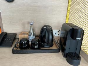 a tray with a printer and other appliances on a desk at IBIS Styles Kaunas Centre in Kaunas