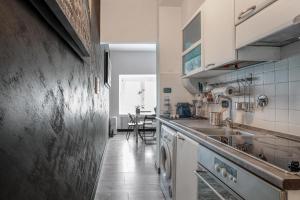 a kitchen with a sink and a washing machine at Casa Enriqueta in Rome