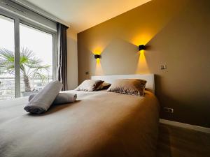 a bedroom with two beds and a large window at Luxury Flat With Terrace & Eiffel Tower View in Paris