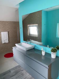 a bathroom with a sink and a mirror at We are tourist in Vila Nova de Gaia +42 photos