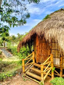 a small hut with a thatched roof at Banteay Srey Women's Only Traditional Spa and Homestay in Kampot