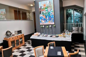 a dining room with a table and a mirror at Hotel Varandas do Atlântico by RIDAN Hotels in Praia da Vitória