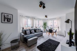 a living room with a couch and a table at ComfySleep Apartments in Glasgow