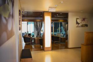 a lobby with chairs and a person sitting in a room at Hotel Varandas do Atlântico by RIDAN Hotels in Praia da Vitória