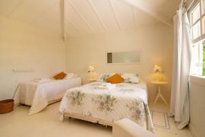 Cama o camas de una habitación en Harmoniosa Mansão a poucos passos da Praia