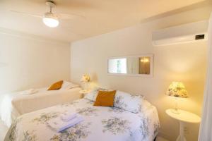 Cama o camas de una habitación en Harmoniosa Mansão a poucos passos da Praia
