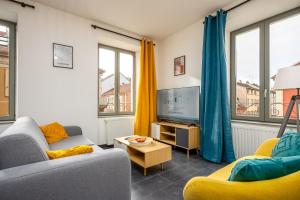 a living room with two couches and a tv at Le 10-GregIMMO-Appart'Hôtel in Belfort