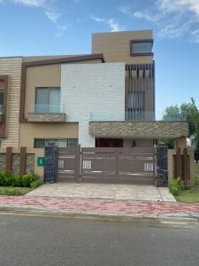 a house with a fence in front of it at The Bahria Town Hotel & Suites in Lahore