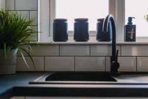 a kitchen counter with a sink and a window at Emirates ApartHOUSE in Glasgow