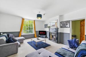 a living room with couches and a fireplace at The Bristol Harbourside Apartments - Sleeps 16 in Bristol
