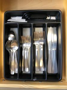 a tray of silver utensils sitting on a shelf at Star Apartments in Fort Myers