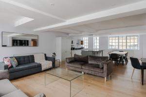 a living room with two couches and a table at Law & Order - Farringdon - by Frankie Says in London