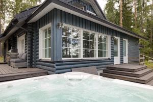 dom z basenem przed nim w obiekcie Lehmonkärki Resort w mieście Asikkala