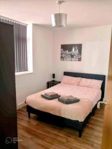 a bedroom with a bed in a room with a window at Urban 2 Bedroom with Parking in West Bromwich