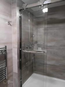 a shower with a glass door in a bathroom at Urban 2 Bedroom with Parking in West Bromwich