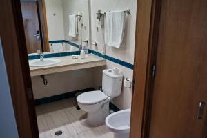 a bathroom with a toilet and a sink at Hotel Varandas do Atlântico by RIDAN Hotels in Praia da Vitória