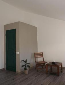 a room with a green door and a chair and a table at JR's House in Yerevan