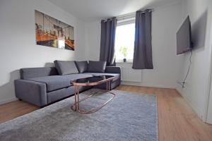 - un salon avec un canapé et une table dans l'établissement Air Apartments 4, à Brême