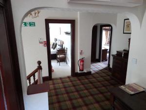 a hallway of a house with a room with a fire extinguisher at Glenorchy Lodge-Rooms Only in Dalmally