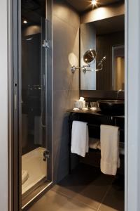 a bathroom with a shower and a sink at Hôtel Saint Marcel in Paris