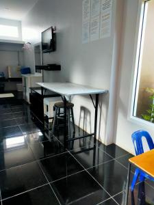 a table in a room with chairs and a kitchen at Nemo 2 Resort in Ao Nang Beach