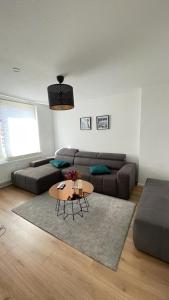 a living room with a couch and a table at Air Apartments 5 in Bremen