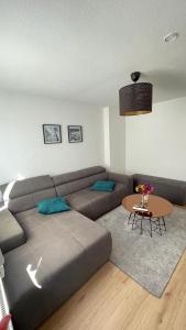 a living room with a couch and a table at Air Apartments 5 in Bremen