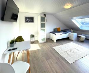 a small attic room with a bed and a table at Monteurwohnung in Bochum in Bochum