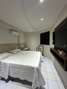 een slaapkamer met een bed en een flatscreen-tv bij 601 Maximum Home in Natal